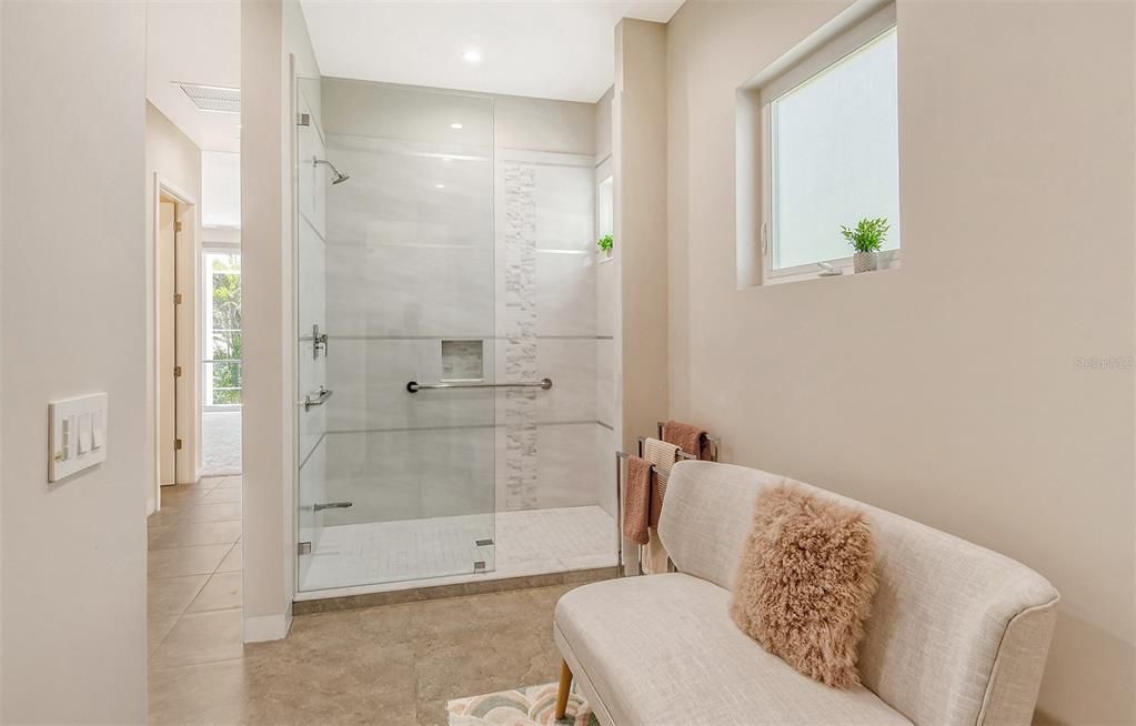 Master bathroom with walk in shower and two walk in closets