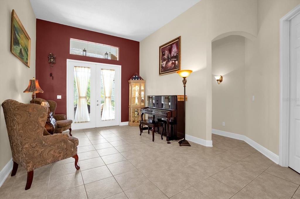 Formal living room with French doors to the pool