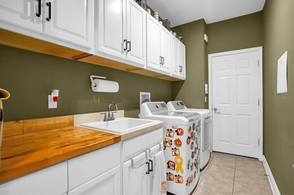 Even more cabinets in your inside laundry room, with a sink and countertop. There's also cabinet that hides you garbage and recycle bin.