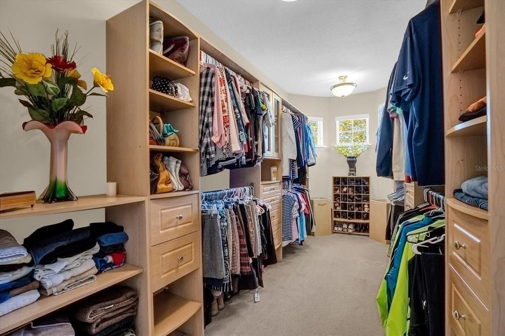 Huge walk=in closet with closet system.