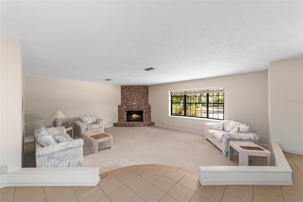 Three living areas to suit your needs. Large enough for home theater. Full length fireplace with Bay Country Window overlooking Jasmine flower beds and palm trees.