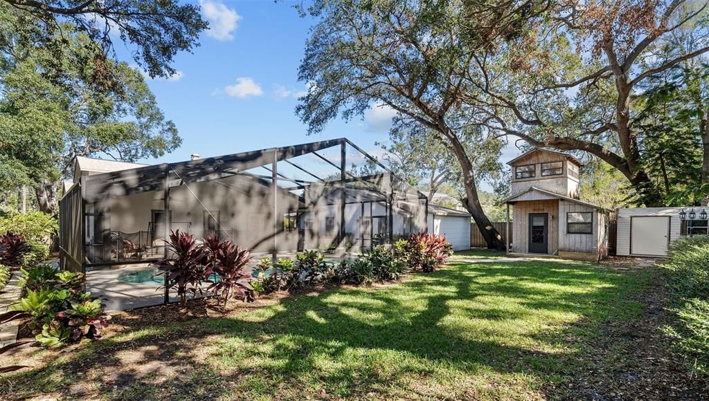 Fully fenced backyard with lush landscaping