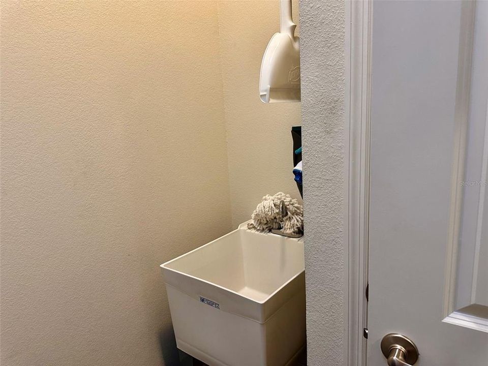 Laundry room has a sink and closet.