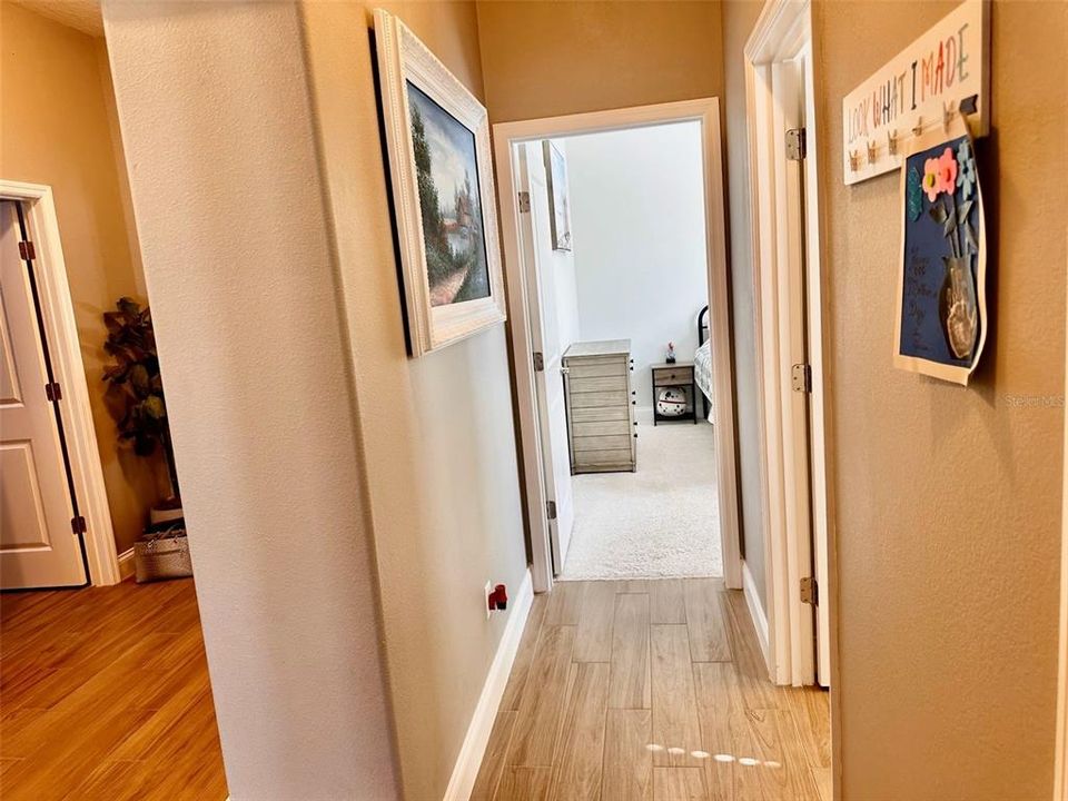 Hallway to guest bathroom and additional 2 bedrooms