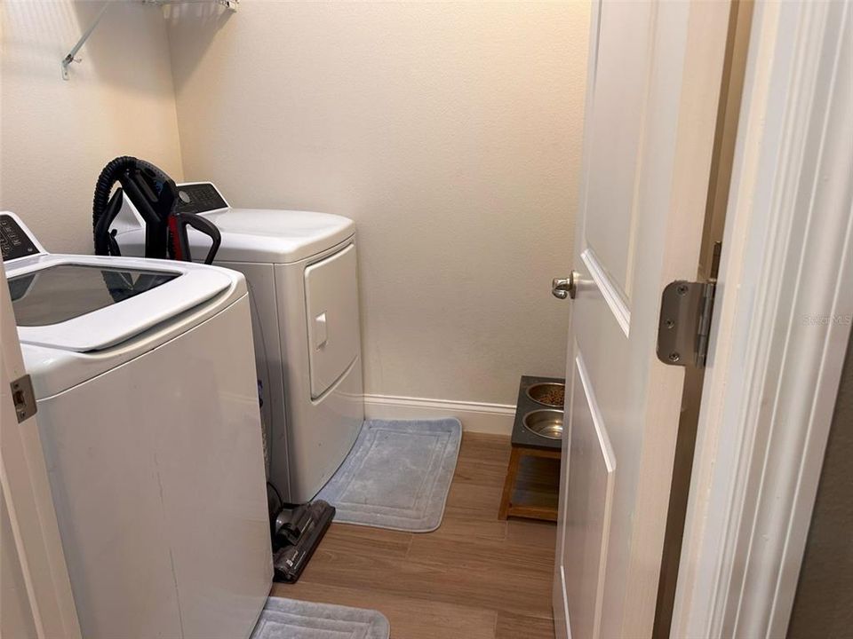 Laundry room is convenient in hallway off of foyer.