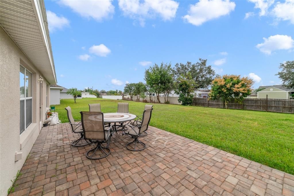 The high ceilings and large windows add to the light and bright feel and for those who seek the outdoors, the living area has access to a paver patio and a backyard that is a perfect blank canvas to create the outdoor space of your dreams.