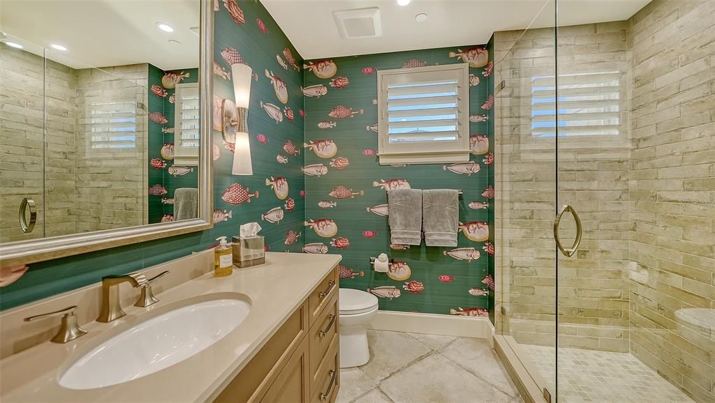 Bath with walk-in shower, linen cabinet.