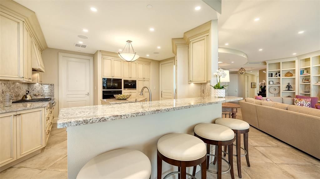 The renovated kitchen has beautiful cabinetry, stylish counter tops and backsplash. Great storage.