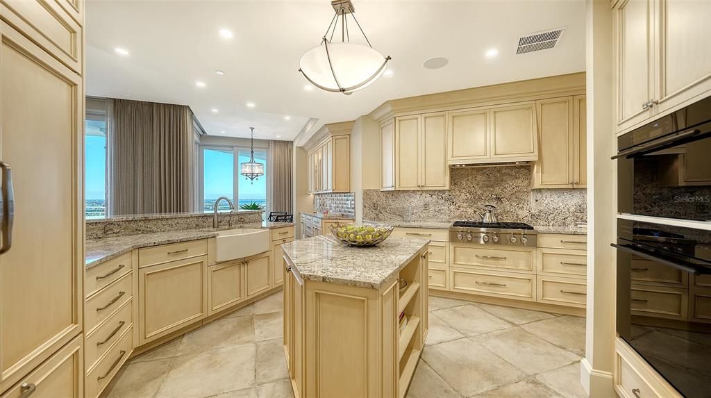 Wolf 6-burner gas range, Wolf exhaust hood, encased in cabinetry.