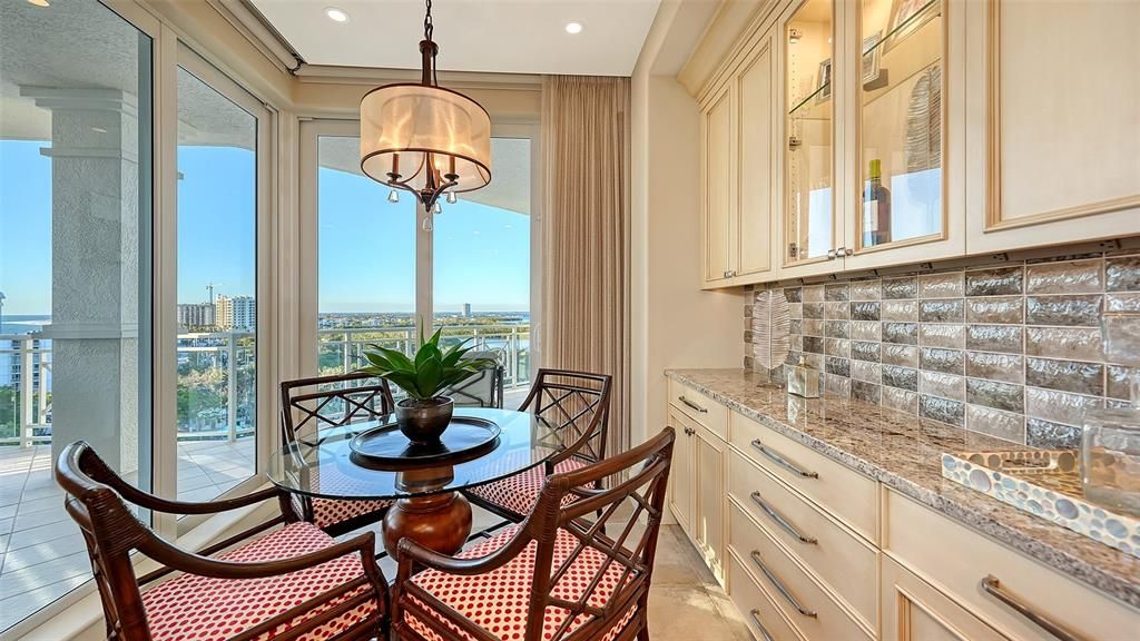 Breakfast room with great views. Attractive dry bar and glass cabinet doors.