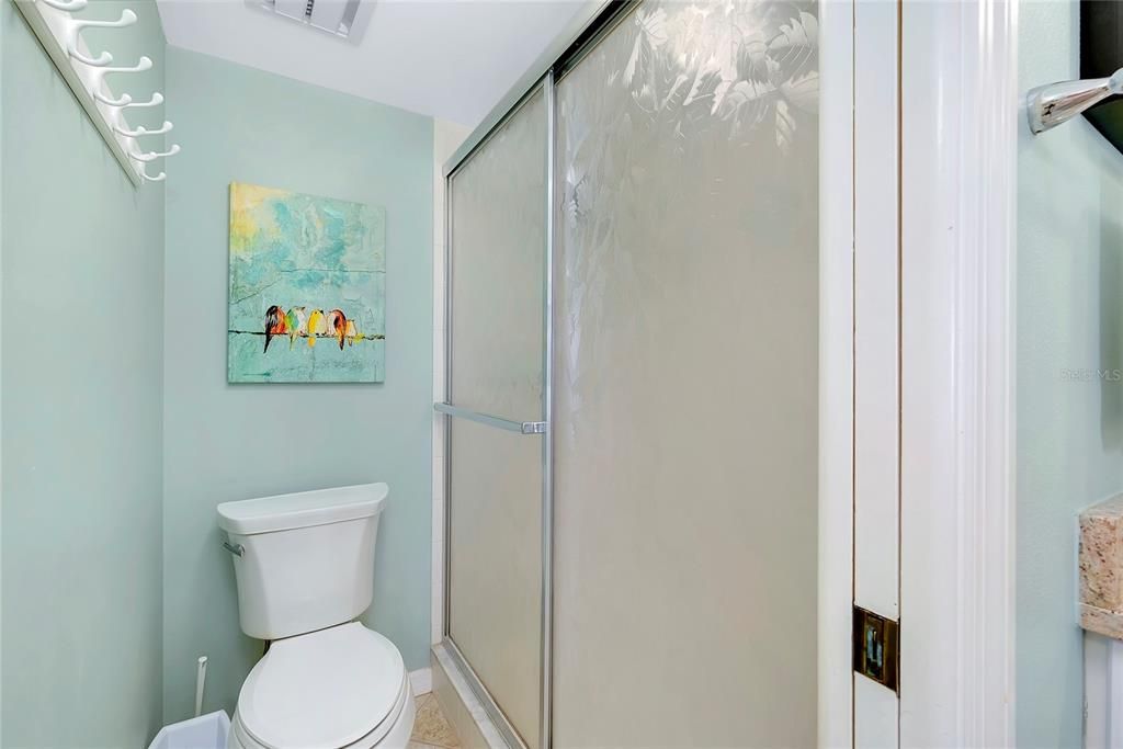 Separate area w/sliding door within the primary bedroom bath.