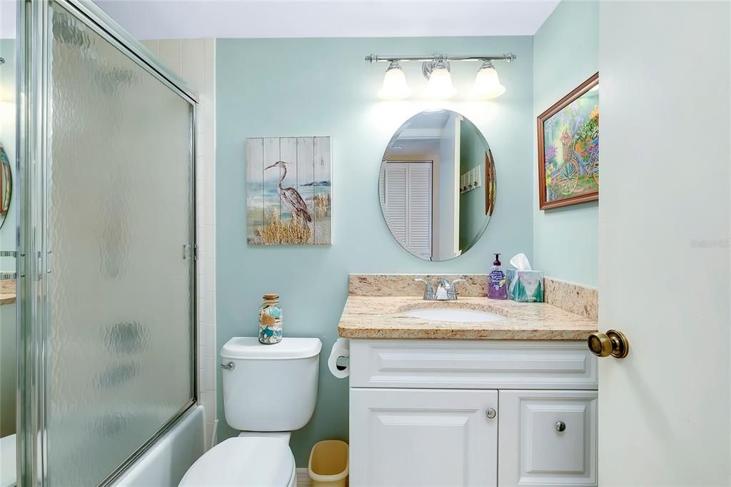 Bath #2 has combined  tub and shower. Tiled floors and tile bath surround.