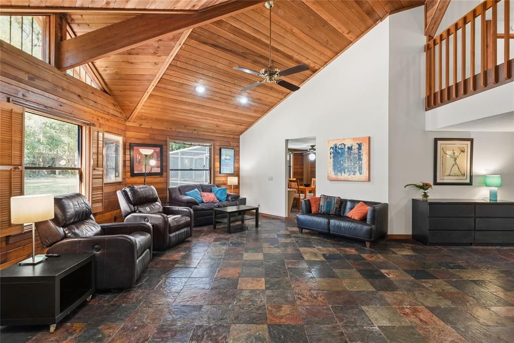 Relax and unwind in this inviting living space, featuring a cozy atmosphere and beautiful wood ceilings.