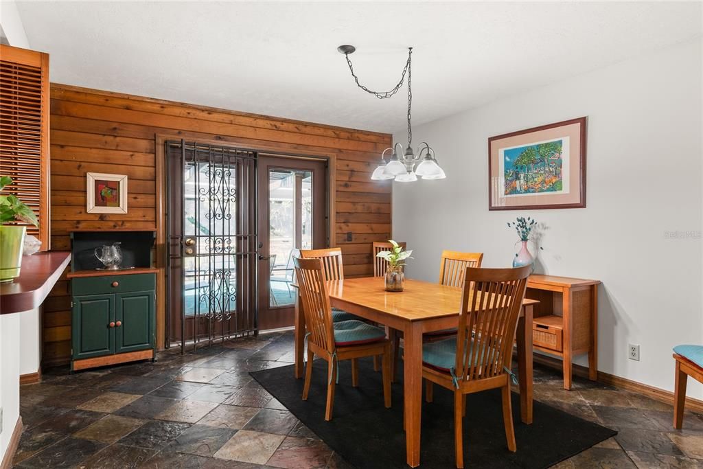 Dining room features access to the patio & pool for easy indoor-outdoor entertaining.