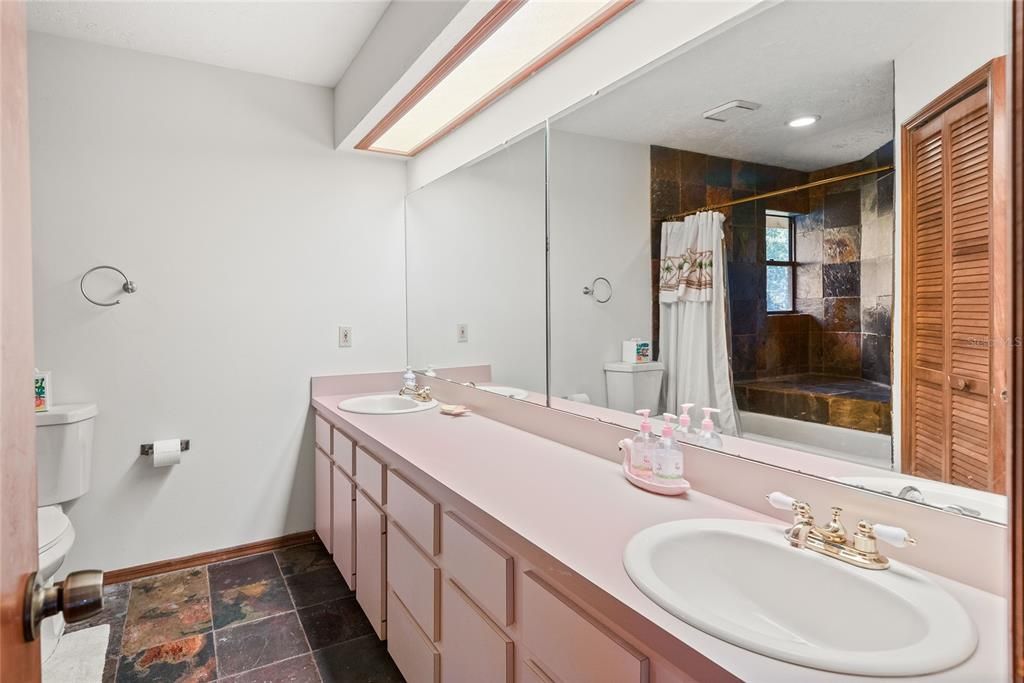 The upstairs bathroom offers a dual sink vanity for added convenience and a tub/shower combination.