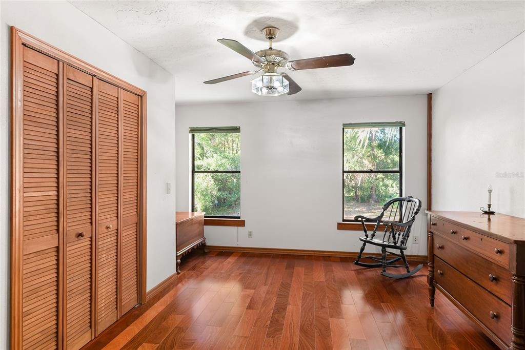 Bedroom 4 -  This bright and airy bedroom features ample closet space and beautiful wood floors.