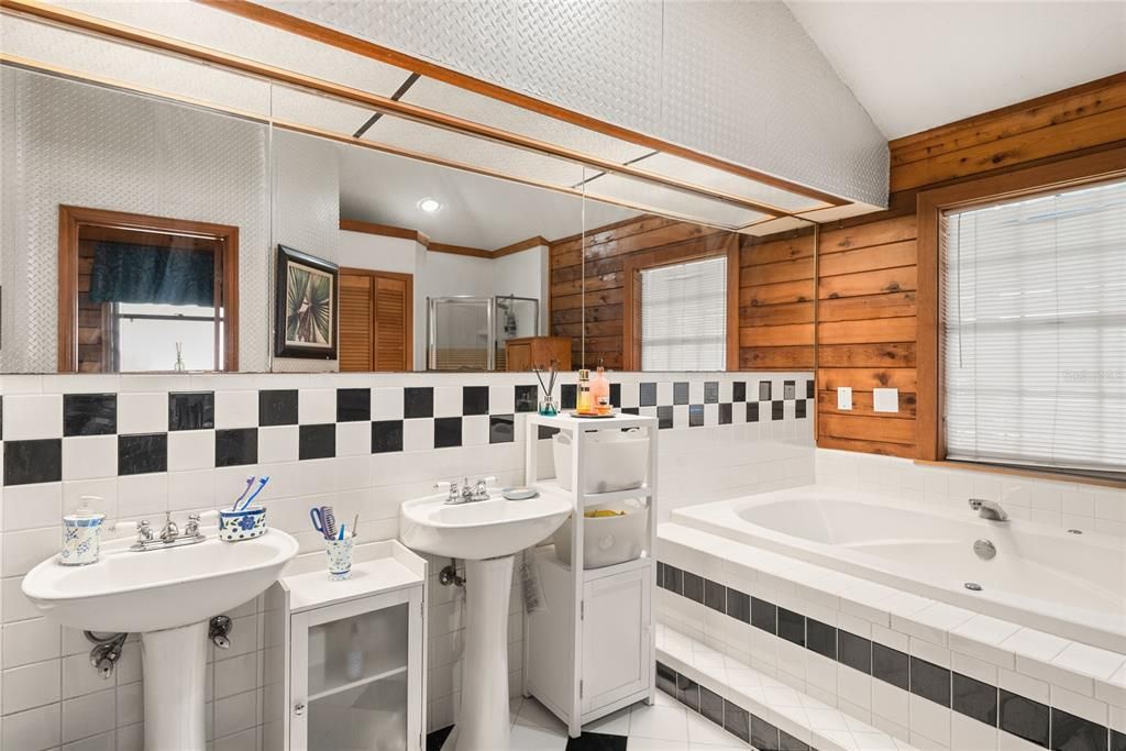 Another view of the primary bathroom showcases the dual vanities and spacious layout.