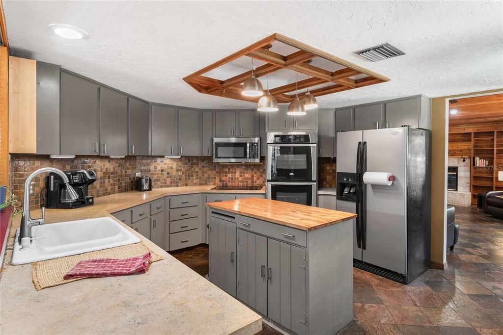 Another view of the kitchen highlights the ample cabinet space and convenient layout.