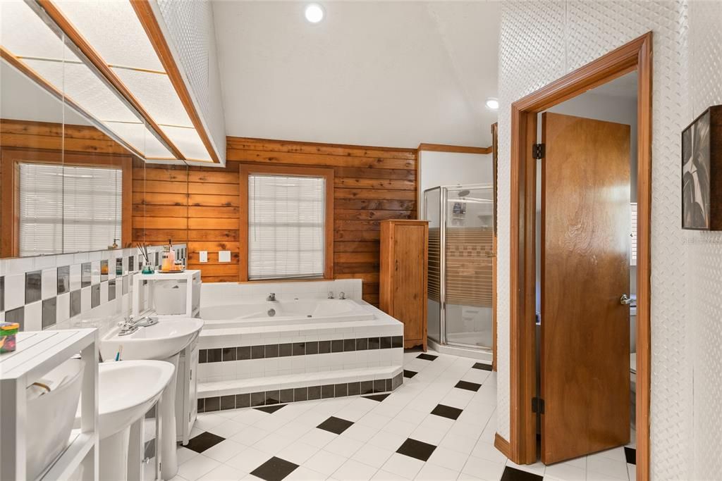 The ensuite primary bathroom features dual sinks, a jetted tub, and a separate shower.