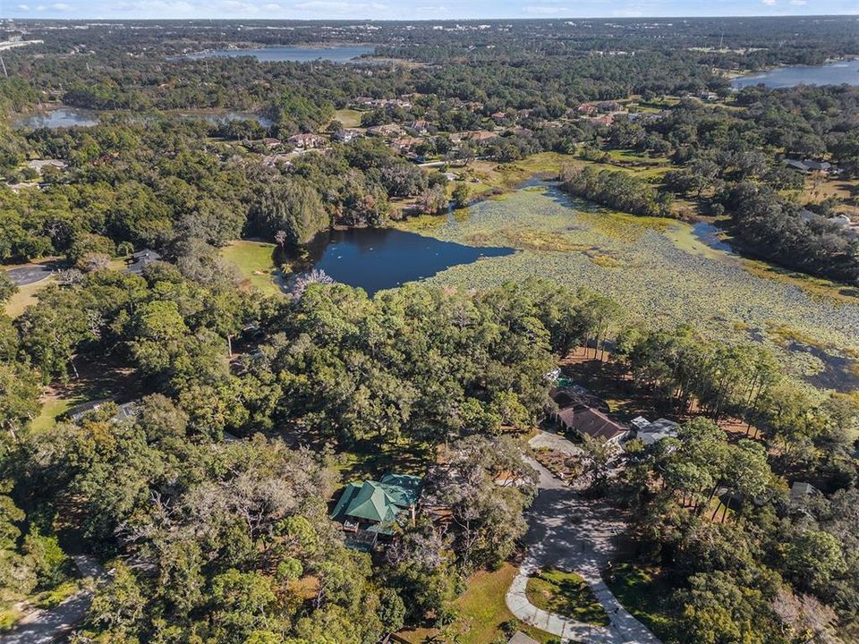 This aerial view showcases the lush surroundings and proximity to Lake Ross.