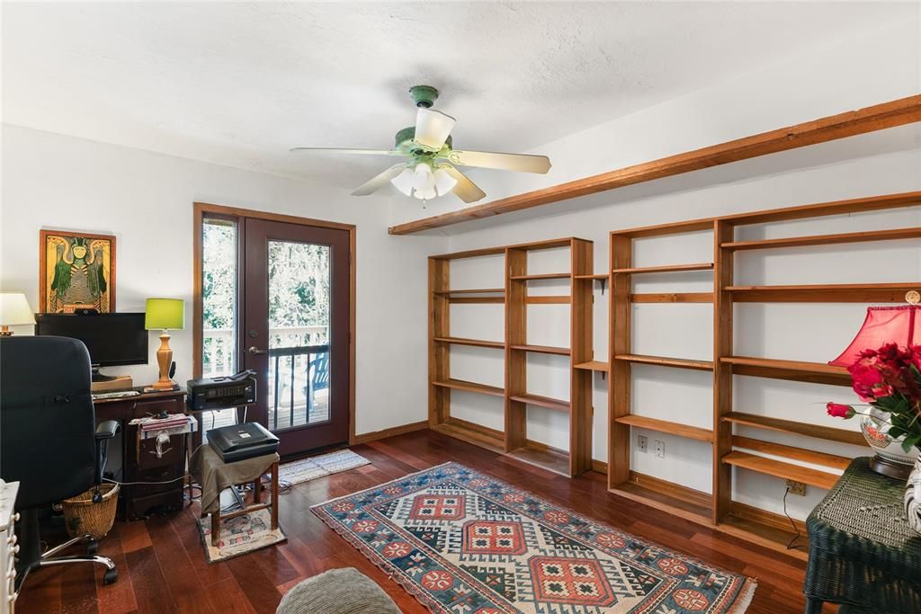 Bedroom 3 - This upstairs bedroom features built-in bookshelves and access to a private balcony overlooking the backyard.