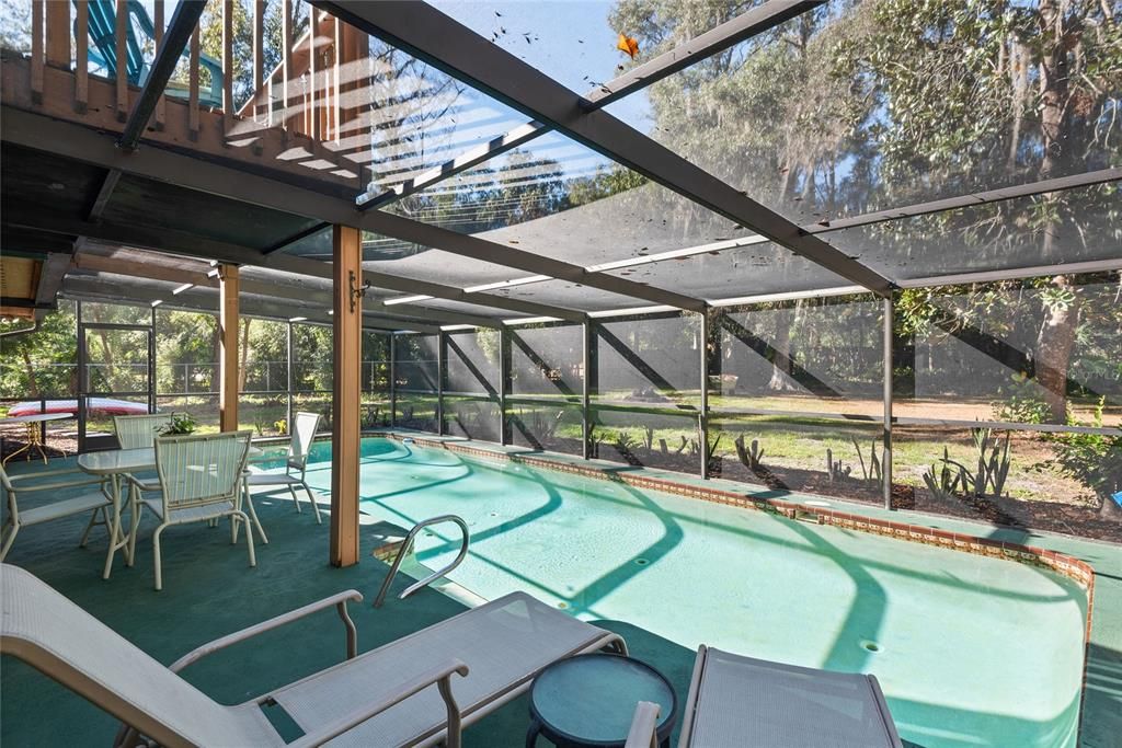 Relax poolside and enjoy the peaceful views of your private backyard oasis.