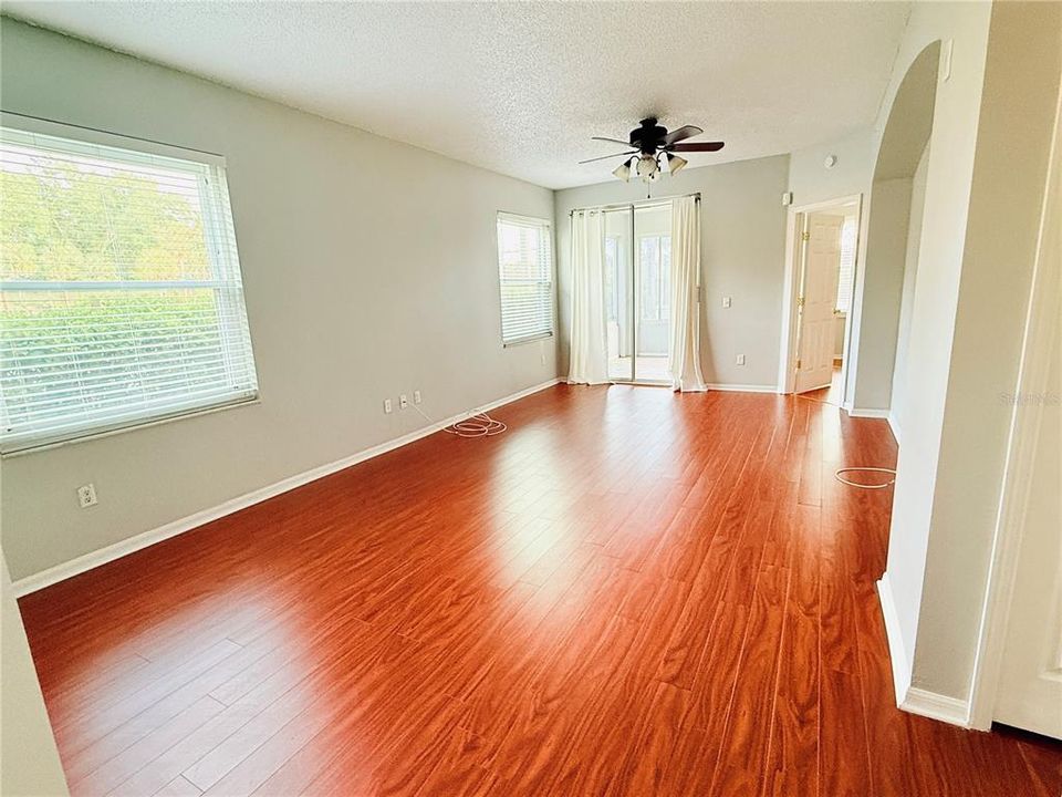 LIVING/DINING COMBO WITH VIEWS OF THE LAKE FROM THE SLIDER THAT LEADS TO THE FLORIDA ROOM