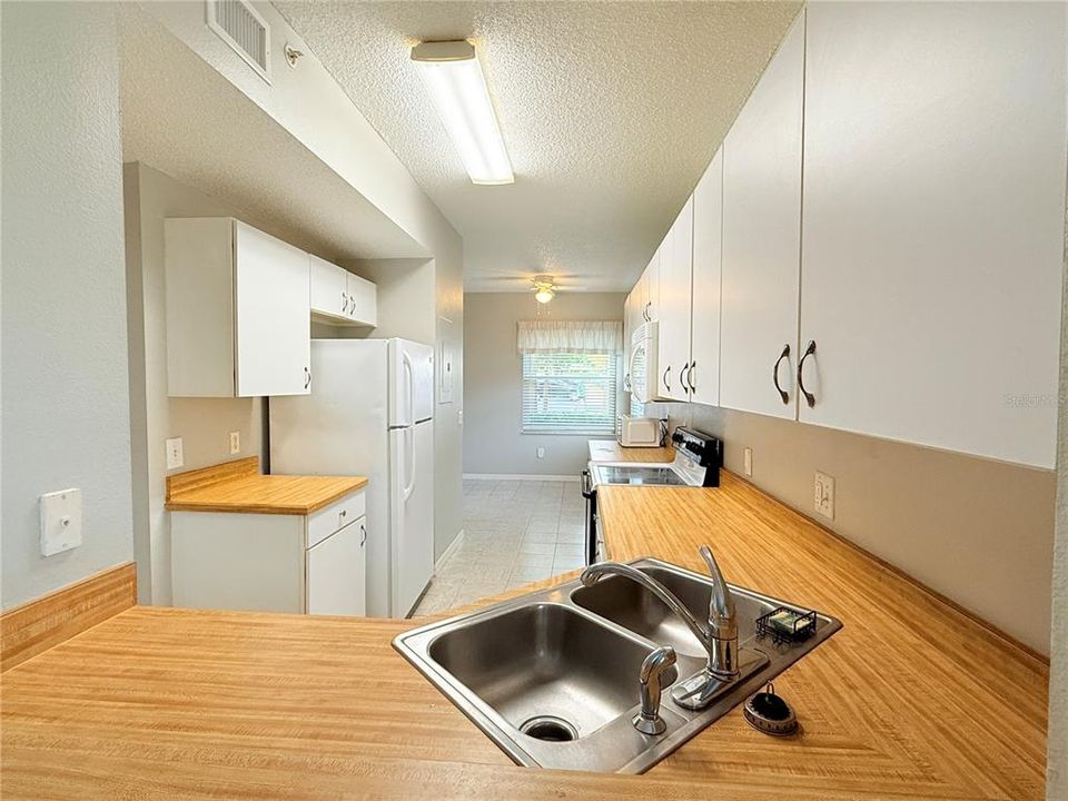 LOOKING INTO THE KITCHEN FROM THE DINING/LIVING ROOM.