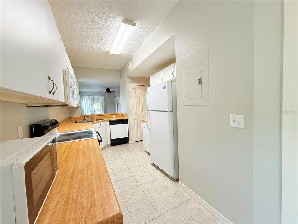 LOOKING FROM THE EATING AREA OF THE KITCHEN TOWARDS THE LIVING/DINING AREA