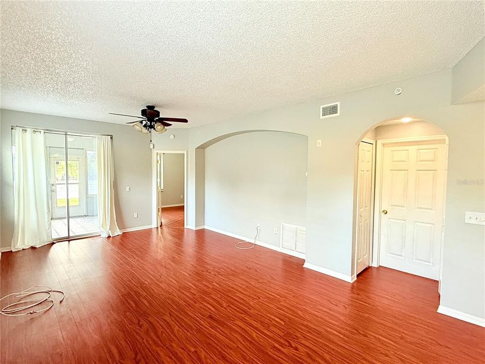 LLIVING ROOM SHOWING THE DOOR TO THE 2ND BATHROOM AND THE ENTRANCE TO THE MASTER BEDROOM