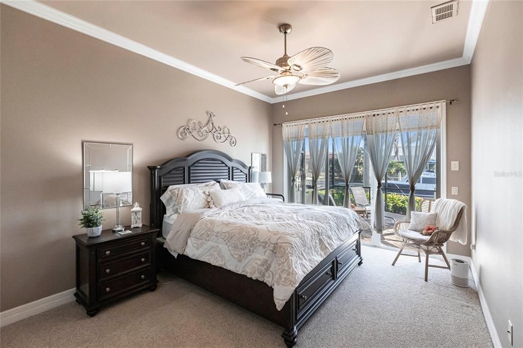 The split-bedroom floor plan ensures this second bedroom with sliding door pool-access offers privacy, and is nearby a pool-access guest bath.