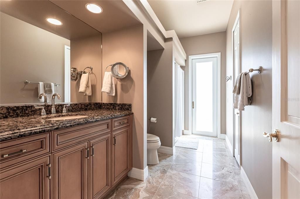 Hallway guest bath offers easy-access to pool.