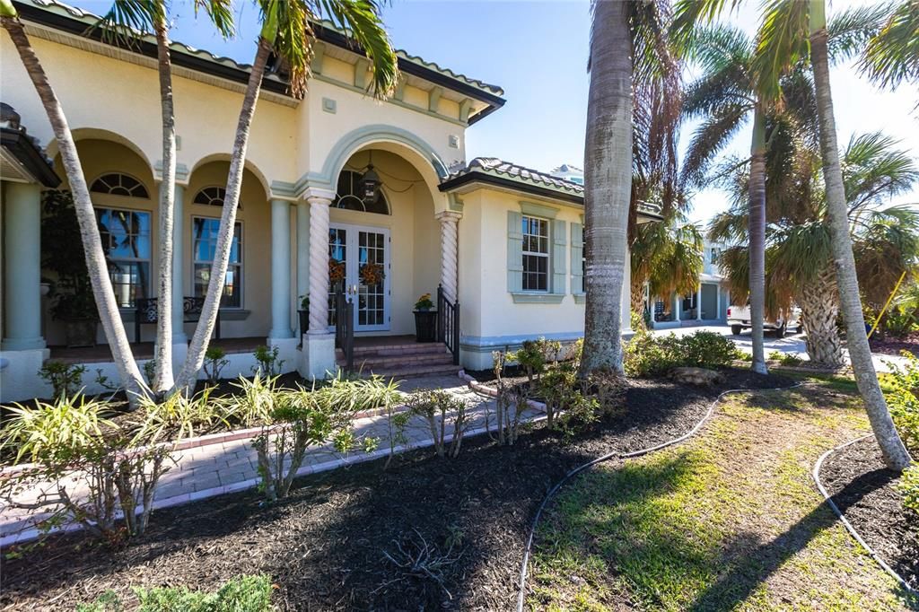 Grand palms and archways create a luxurious front entry.