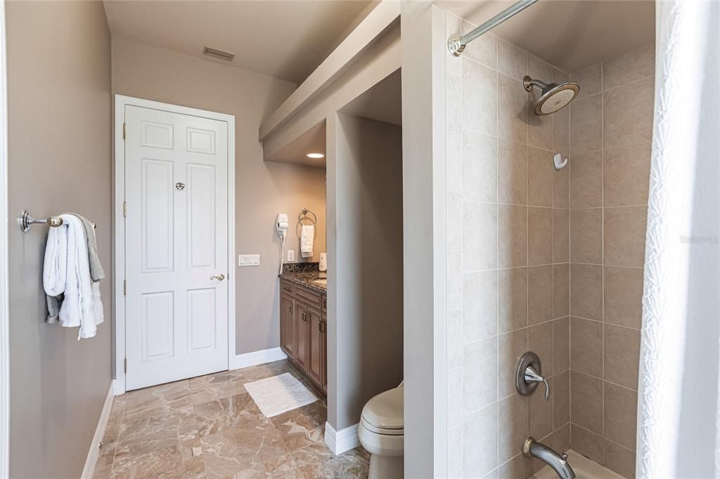 Hallway guest bath offers easy-access to pool.