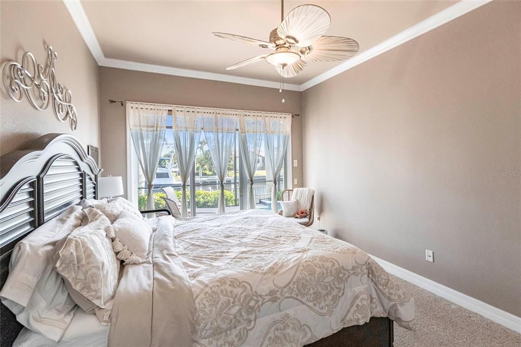 The split-bedroom floor plan ensures this second bedroom with sliding door pool-access offers privacy, and is nearby a pool-access guest bath.