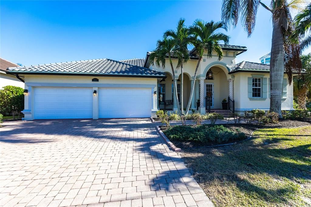 Front Exterior showcasing brick paver driveway and oversized two-car garage.