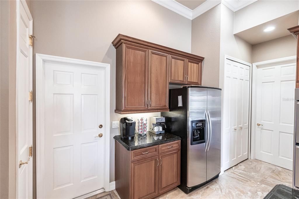 The gourmet kitchen is a chef’s dream, featuring granite countertops, custom wood cabinetry, a center island, breakfast bar, and premium stainless steel appliances, including a 6-burner gas range with hood and built-in double ovens.