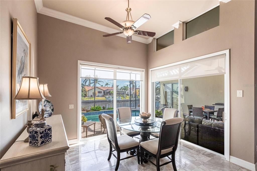 A kitchen-adjacent breakfast nook is perfect for casual dining with serene water views.