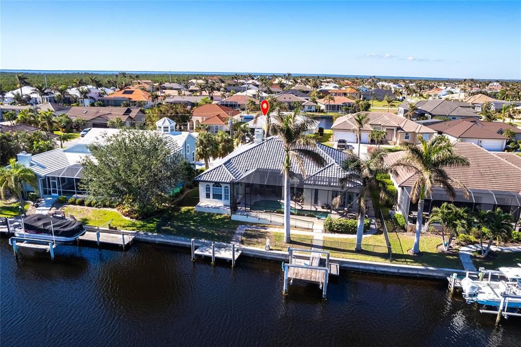 Indulge in the ultimate waterfront lifestyle with this luxurious 3-bedroom, 2-bathroom + den home, nestled along a deepwater canal just minutes from open water, and no bridges limiting height access. Designed for both comfort and sophistication, this exquisite property boasts two private docks, one equipped with a 10,000 lb boat lift and 30-amp power, offering the perfect haven for your boating adventures.