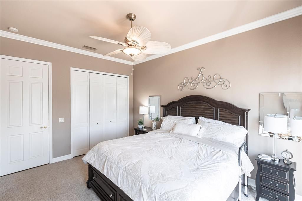 The split-bedroom floor plan ensures this second bedroom with sliding door pool-access offers privacy, and is nearby a pool-access guest bath.