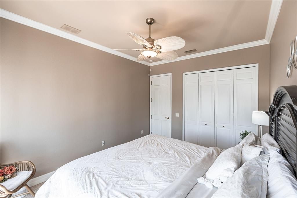 The split-bedroom floor plan ensures this second bedroom with sliding door pool-access offers privacy, and is nearby a pool-access guest bath.