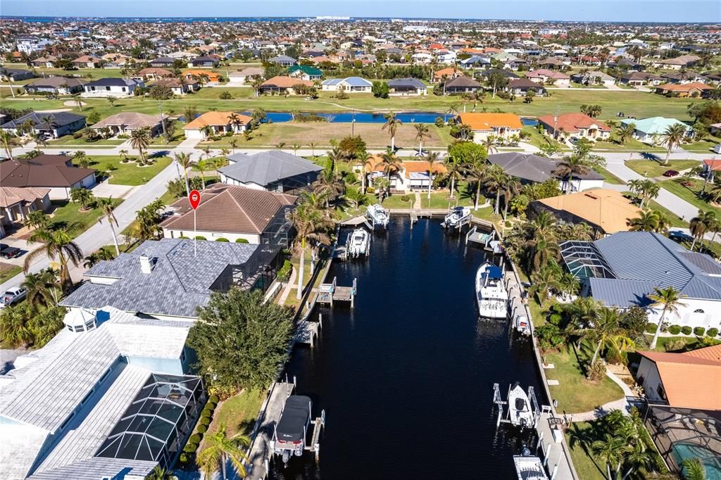 Indulge in the ultimate waterfront lifestyle with this luxurious 3-bedroom, 2-bathroom + den home, nestled along a deepwater canal just minutes from open water, and no bridges limiting height access. Designed for both comfort and sophistication, this exquisite property boasts two private docks, one equipped with a 10,000 lb boat lift and 30-amp power, offering the perfect haven for your boating adventures.