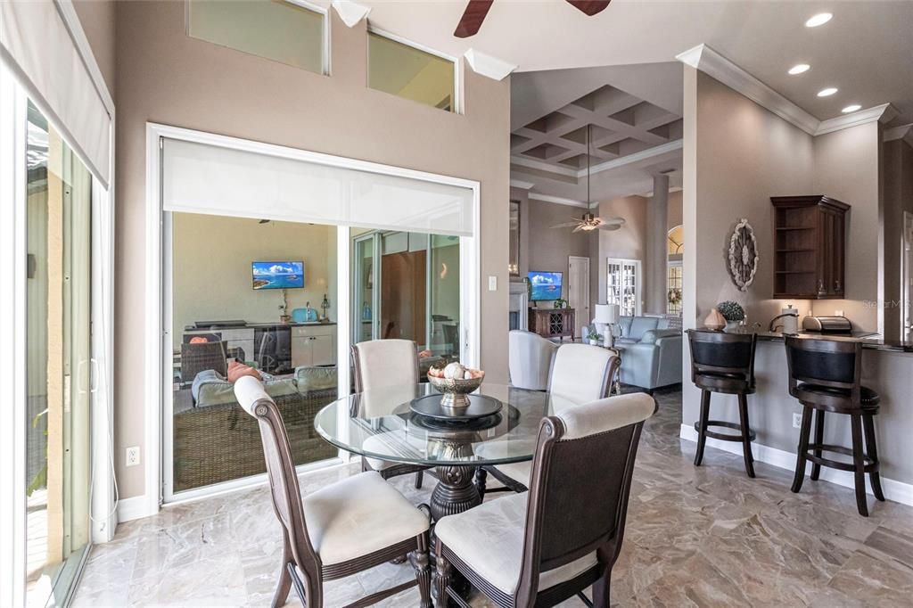 A kitchen-adjacent breakfast nook is perfect for casual dining with serene water views.