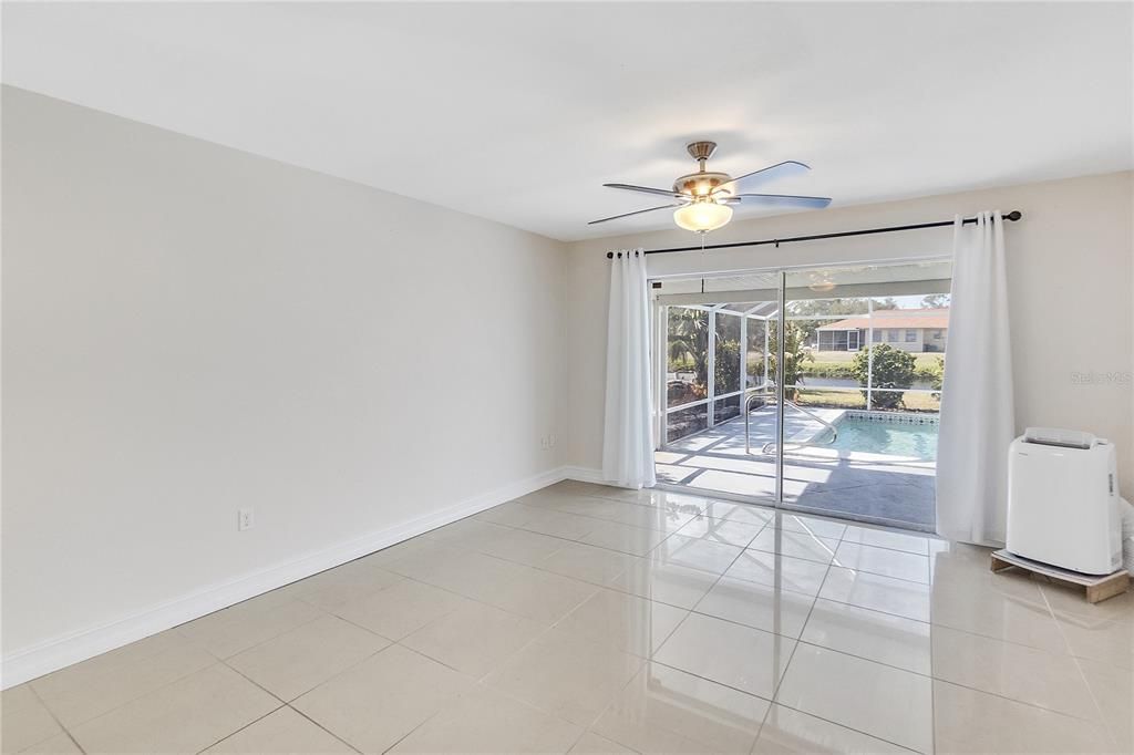 PRIMARY BEDROOM WITH SLIDER DOORS TO THE POOL