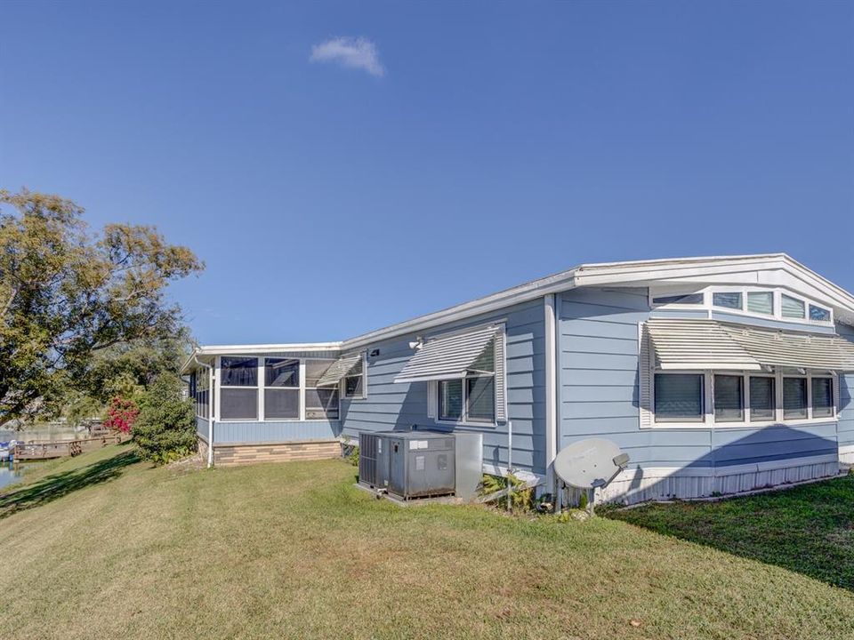 Back yard with a lanai and screen room.