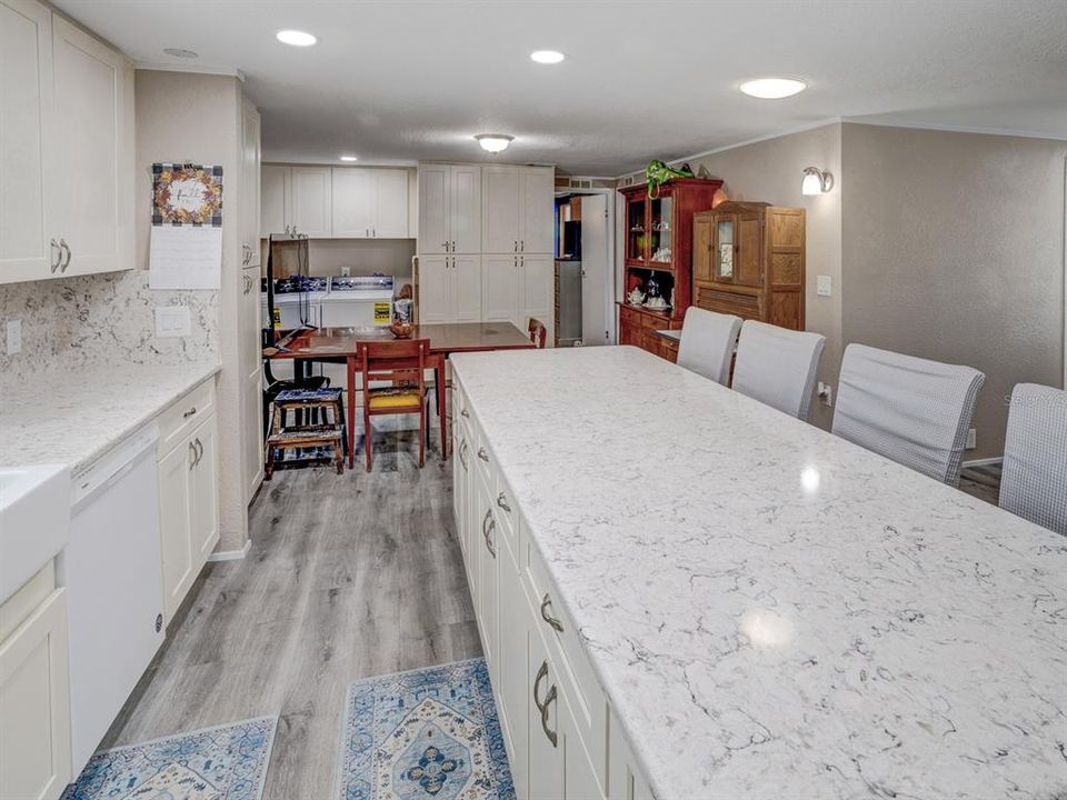 Kitchen with antique white shaker cabinets and a solid surface Cortez countertop.