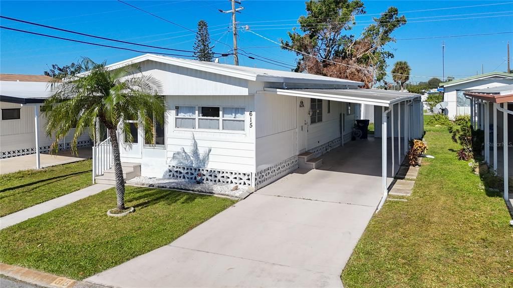 Carport and driveway provide ample parking for at least cars.