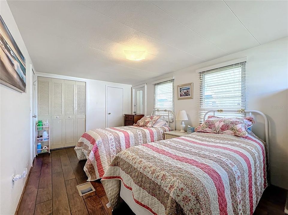 Primary bedroom with a half bathroom and stackable washer and dryer.