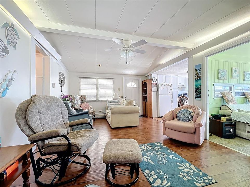 Another view of the living room with the sunroom to the right.