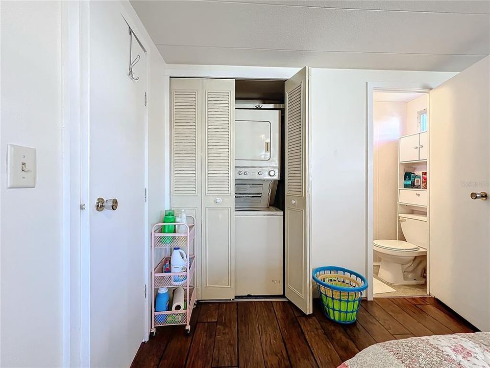 Closer view of the stackable washer/dryer and half bath.